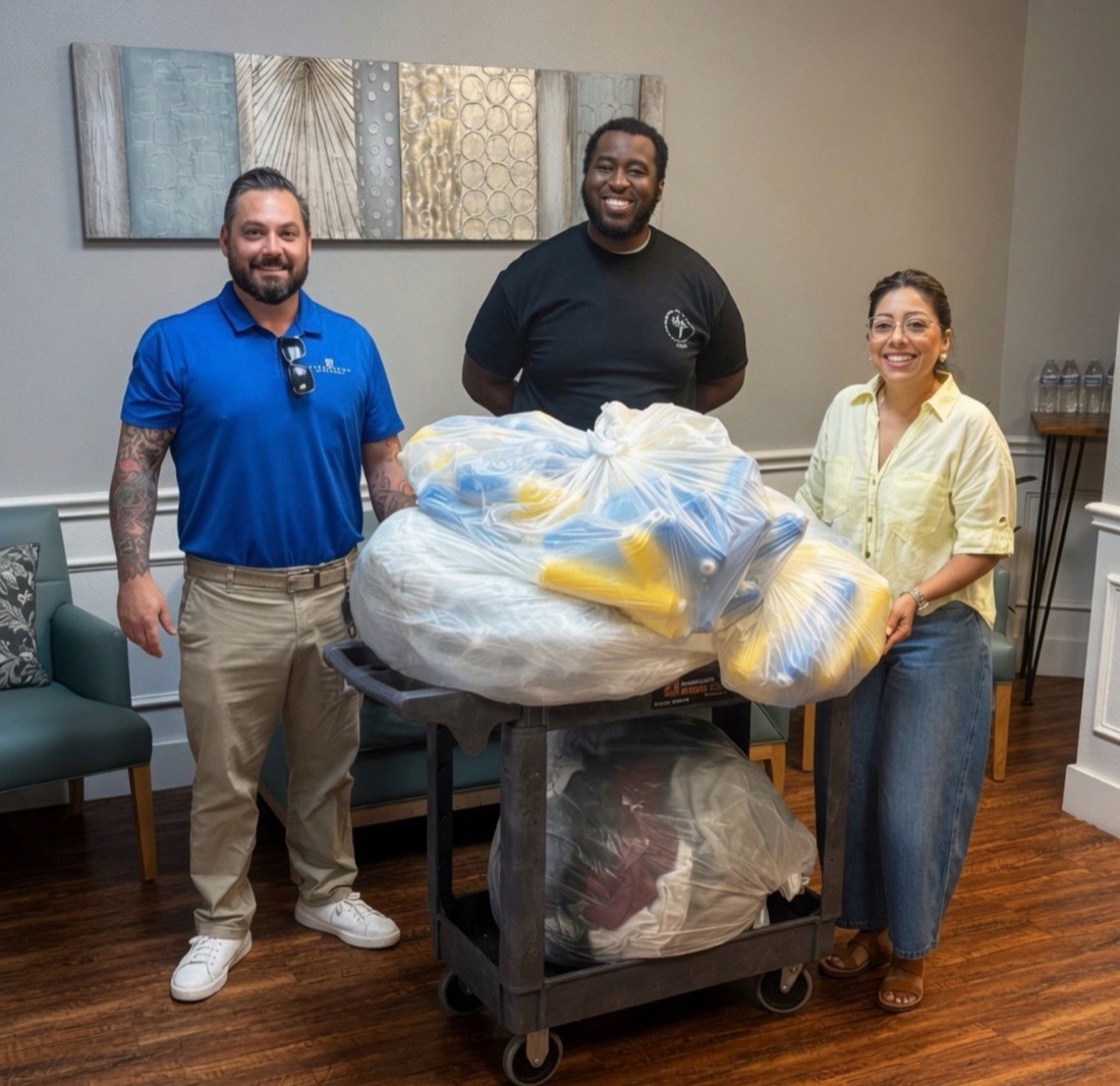 Superhost associates with a cart of donated goods
